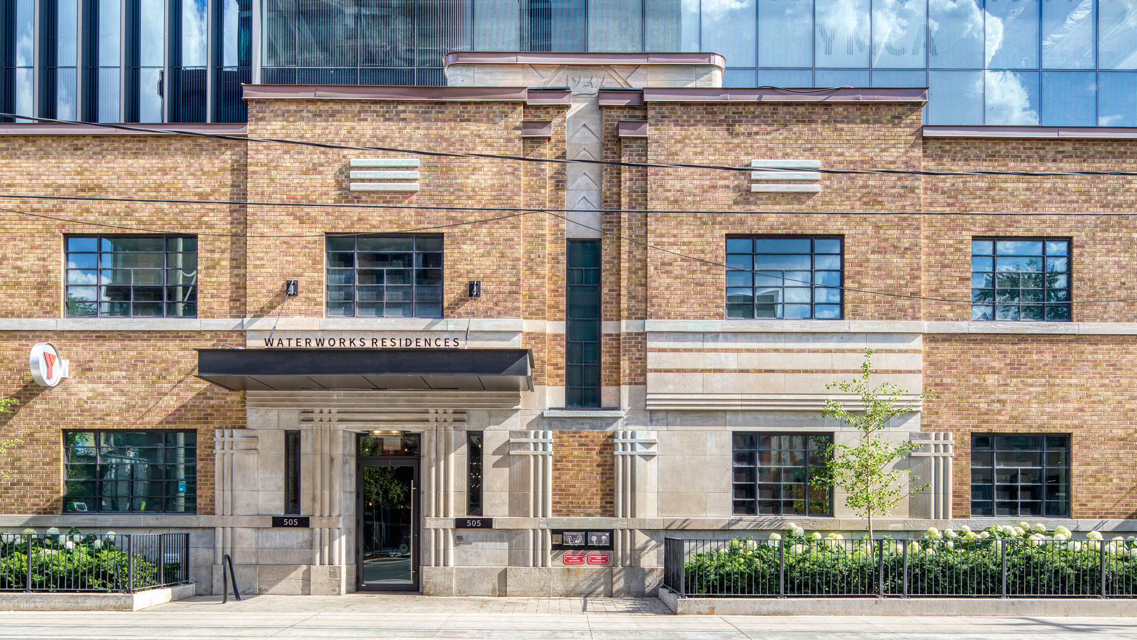 Watermarks Residences brick building and its front sign during the day