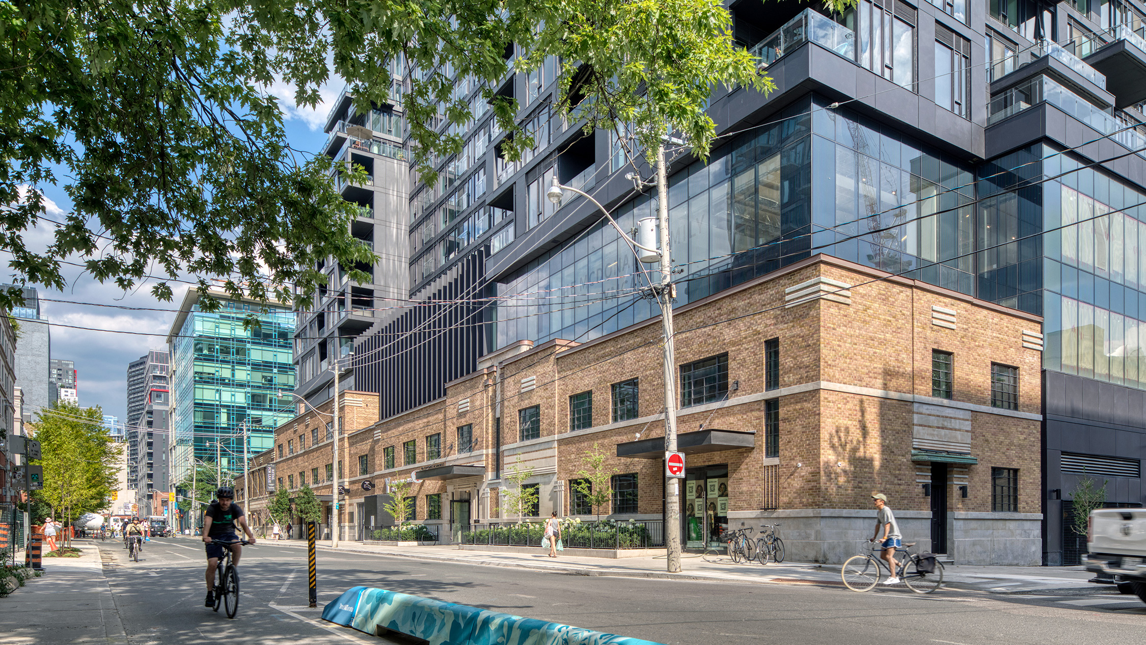 A street with people biking and Waterworks Residences
